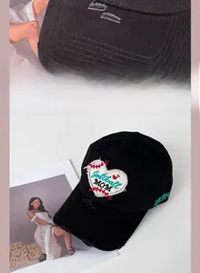 Detail of distressed black baseball cap with Softball MOM embroidery and ripped brim