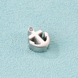 Close-up of silver stainless steel anchor pendant with a sparkling diamond inlay detail