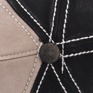 Close-up of contrast stitching on the top of this washed denim baseball hat