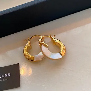 Elegant gold earrings with round mother of pearl inlay and Confession engraving