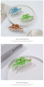 Detailed view of jelly color snake-shaped hair clips in blue, green and brown resin finish