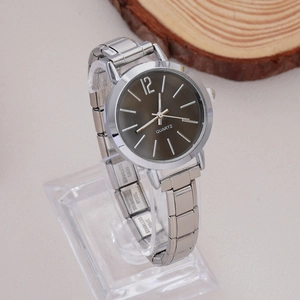 Close-up of silver quartz watch with grey dial and stainless steel strap on display stand