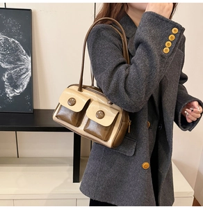 Detail view of a vintage contrast-color shoulder bag with decorative button pockets