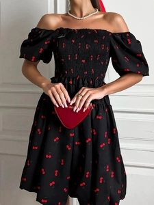 Detail of square neck puff sleeve dress with red cherry print and elastic smocking