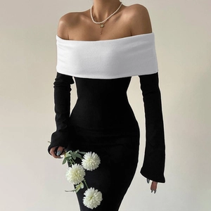 Detail of the elegant black and white off-shoulder slim-fit dress with white fold-over collar