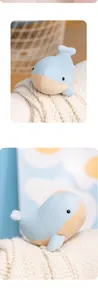 Detail of blue whale plush toy featuring soft fabric and beige corduroy belly texture