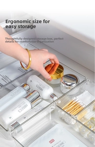 Detailed close-up of a clear multi-compartment PET organizer with partitions for cosmetics