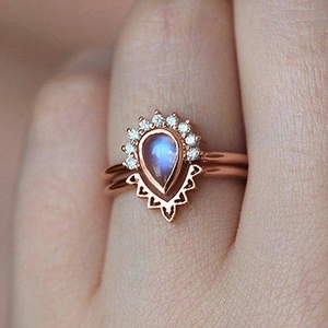 Bohemian rose gold ring set featuring pear-shaped moonstone and crown diamond band