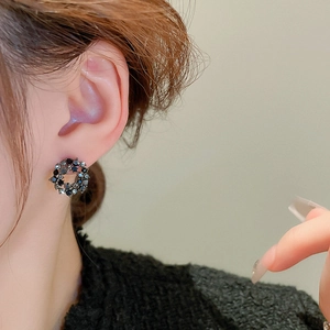 Vintage dark style circle stud earrings with black rhinestones shown on model