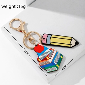 Detailed view of teacher appreciation keychain with rainbow pencil and apple charms