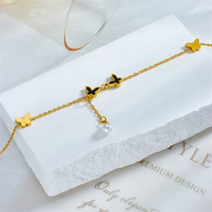Golden titanium steel butterfly anklet with pearls and black enamel charms on stone