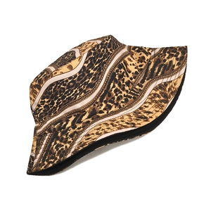 Detail of double-sided leopard print bucket hat with striped pattern and black lining