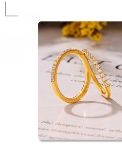 Close-up of two thin 18K gold plated PVD rings with shimmering zircon stones