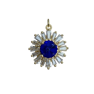 Gold sunflower pendant with blue central stone and clear crystal petals on white background
