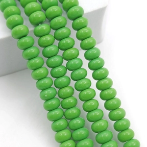 Close-up of emerald green 8x5mm abacus glass beads for DIY jewelry making