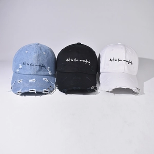 Distressed denim baseball cap with metal rings and Art is for everybody embroidery