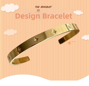 Detail of 18k gold-plated bangle with sparkling zircon inlays in star-shaped patterns