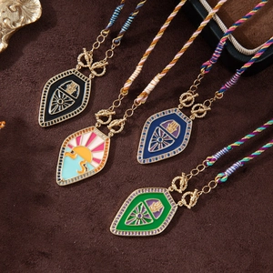 Vintage tarot shield necklaces with colorful enamel and gemstone pendants on velvet background