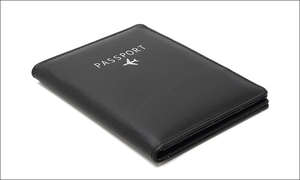 Close-up of black PU leather passport holder featuring RFID protection and embossed text