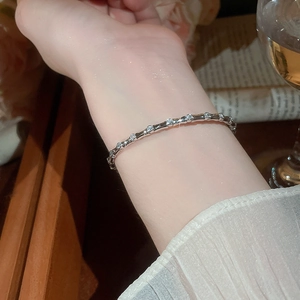 Close-up of a silver bamboo joint bracelet with cubic zirconia on a female wrist