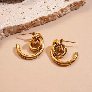 Detail shot of 18k gold plated stainless steel twisted hoop earrings on stone
