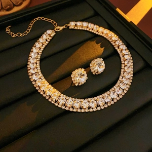 Detail of square crystal jewelry set with double-layer necklace and earrings on black velvet