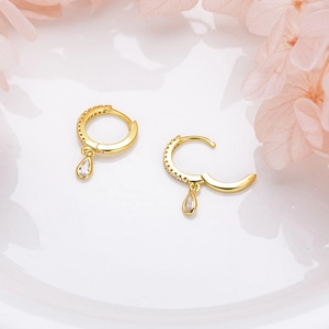 Detailed view of elegant gold drop earrings with water drop zirconia and floral petals