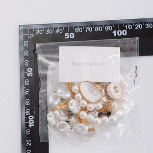 Bohemian beach necklace with white pearls, starfish pendant and shell charm on white background