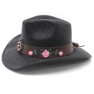 Detail of black straw cowboy hat with floral embroidery and pink gemstone ornament