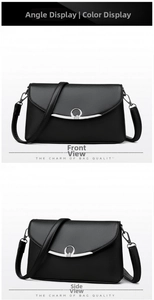 Detail of black litchi texture leather crossbody bag with silver heart metal buckle