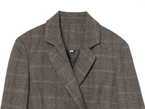 Close-up of the collar and tweed fabric texture on a dark brown plaid blazer jacket