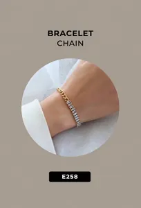 Macro detail of gold-plated bracelet featuring a mix of cubic zirconia and curb chain links
