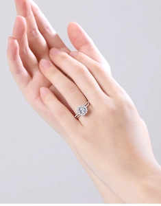 Close-up of elegant s925 silver moissanite snowflake ring on female model's finger