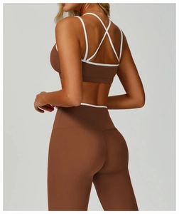 Detail of the cross-back straps and white piping on this brown sports bra set