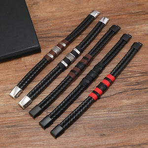 Five men's double-layer braided leather bracelets with magnetic clasps on wooden background