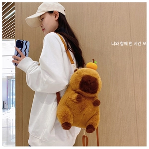 Close-up of cute capybara plush backpack with orange detail and adjustable PU straps