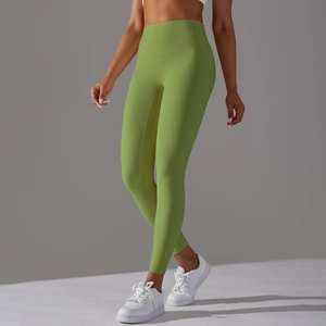 Detailed macro view of the high-waisted seamless waistband on light green yoga pants