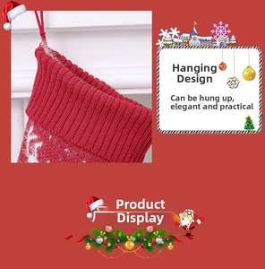 Detail of red knit Christmas stocking featuring white snowflakes and a hanging loop