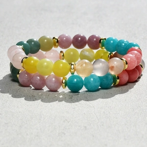 Detailed close-up of 8mm natural stone beaded bracelets with golden spacer accents