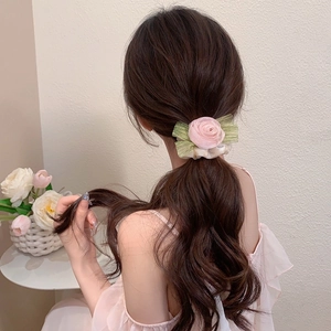 Close-up of pink rose fabric scrunchie with green leaves on high-elastic mesh hair tie