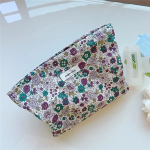 Detail of floral cotton makeup bag with simple wish label and soft texture