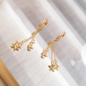 Elegant gold celestial earrings featuring star and moon charms with zircon inlays