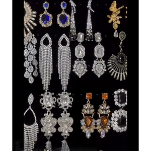 Exaggerated vintage silver needle earrings with rhinestones on black velvet display