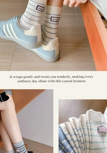 Detailed view of striped cotton mid-calf socks with sports sneakers and knit texture