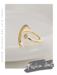 Macro shot of gold star and moon open ring featuring sparkling pave zircon details