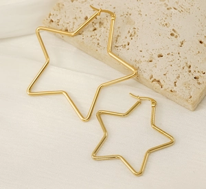 Detailed view of two pairs of gold-plated stainless steel star-shaped hoop earrings