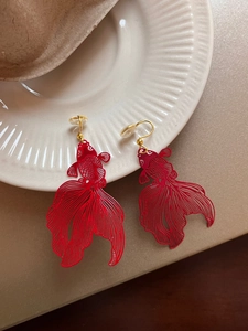 Detailed close-up of intricate hollow red koi fish earrings with elegant gold hooks
