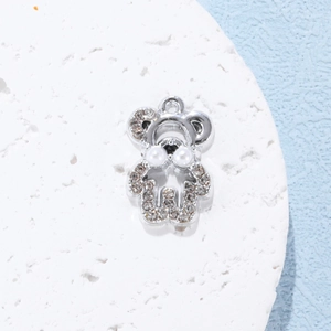 Detail of silver bear pendant featuring micro-pave rhinestones and two white pearls