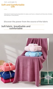 Detail of coral fleece towel set with honeycomb texture and elegant ribbon packaging