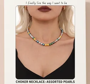 Detail of a multi-colored metallic bead necklace featuring gold, silver, blue, and green beads